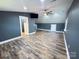 Spacious bonus room features hardwood floors, a ceiling fan, and an entrance to bathroom at 245 Clontz Hill Rd, Troutman, NC 28166