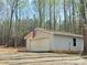Detached garage with American flag accent, siding, and single window in a tree-filled lot at 245 Clontz Hill Rd, Troutman, NC 28166