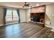 Cozy living room with hardwood floors and a brick fireplace, perfect for relaxing evenings at 245 Clontz Hill Rd, Troutman, NC 28166