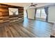 Bright living room featuring stylish wood accent wall, hardwood floors, and large windows at 245 Clontz Hill Rd, Troutman, NC 28166