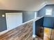 Loft showcasing wood floors and a staircase leading to the lower level at 245 Clontz Hill Rd, Troutman, NC 28166