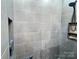 Modern shower features gray tile, a built-in shelf, and a handheld shower head at 245 Clontz Hill Rd, Troutman, NC 28166