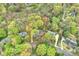 An aerial view shows a home with mature trees on a large lot in a residential neighborhood at 2605 Winding Oak Dr, Charlotte, NC 28270