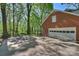 Brick house with a two-car garage and a basketball hoop in a large backyard at 2605 Winding Oak Dr, Charlotte, NC 28270