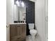 Modern bathroom featuring a wood vanity, black hexagon tiles, and a glass-door shower at 2605 Winding Oak Dr, Charlotte, NC 28270