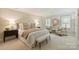 A beautifully staged bedroom featuring a plush bed, sitting area, and neutral color palette at 2605 Winding Oak Dr, Charlotte, NC 28270