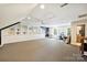Spacious bonus room with custom built-ins, a built-in desk, and unique architectural details at 2605 Winding Oak Dr, Charlotte, NC 28270