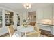 Bright breakfast nook featuring a round table, wicker chairs, and natural light from surrounding windows at 2605 Winding Oak Dr, Charlotte, NC 28270