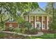 Traditional brick home with a columned front porch and manicured landscaping at 2605 Winding Oak Dr, Charlotte, NC 28270