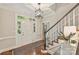 Entryway foyer featuring a staircase, hardwood floors, and a view of the front door at 2605 Winding Oak Dr, Charlotte, NC 28270
