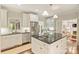 Bright kitchen features white cabinets, stainless steel appliances, and a large center island with a stone countertop at 2605 Winding Oak Dr, Charlotte, NC 28270