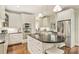 Modern kitchen boasts white cabinets, dark countertops, stainless steel appliances, and a central island with seating at 2605 Winding Oak Dr, Charlotte, NC 28270