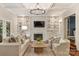 Beautifully decorated living room with fireplace, built-ins and coffered ceilings at 2605 Winding Oak Dr, Charlotte, NC 28270