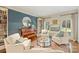 Cozy living room featuring a piano, bookshelves, and comfortable seating at 2605 Winding Oak Dr, Charlotte, NC 28270