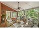 Relaxing screened-in porch with brick flooring, comfortable wicker seating, and views of the peaceful, green landscape at 2605 Winding Oak Dr, Charlotte, NC 28270