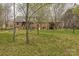 View of the back of the house with trees surrounding the yard at 2705 Robinson Rd, Newton, NC 28658