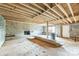 Unfinished basement with a brick fireplace and exposed ceiling beams at 2705 Robinson Rd, Newton, NC 28658