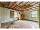 Bedroom with paneled walls, and natural light perfect for renovation at 2705 Robinson Rd, Newton, NC 28658