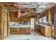 Renovation opportunity: Spacious kitchen with vintage cabinets and exposed ceiling awaiting remodel at 2705 Robinson Rd, Newton, NC 28658
