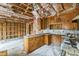 Kitchen space with wooden cabinets, marble countertops, and exposed framework and insulation at 2705 Robinson Rd, Newton, NC 28658