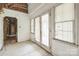 Open living room with French doors, large windows, and exposed framework and insulation at 2705 Robinson Rd, Newton, NC 28658