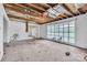 White painted room with exposed wooden ceiling and big windows at 2705 Robinson Rd, Newton, NC 28658