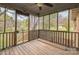 View of a screened porch with wood flooring and walls and screens looking out on trees at 2705 Robinson Rd, Newton, NC 28658