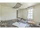 Wrecked bedroom with ceiling damage, debris, and a window, presenting a complete renovation project at 303 E Fisher St, Salisbury, NC 28144