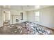 Empty living room with hardwood floors, a window, and a fireplace at 303 E Fisher St, Salisbury, NC 28144