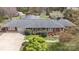 A charming brick home featuring a well-maintained roof and an attached garage, all set within a beautifully landscaped yard at 317 S Lineberry St, Troy, NC 27371