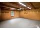 Spacious basement with wood walls, ample lighting and storage shelves at 317 S Lineberry St, Troy, NC 27371