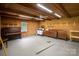 Spacious basement with wood walls, piano, stove and ample storage shelves at 317 S Lineberry St, Troy, NC 27371