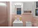 Bathroom featuring white ceramic tile and white cabinets and a sink at 317 S Lineberry St, Troy, NC 27371