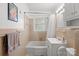 Bathroom featuring a combination shower and bathtub with beige ceramic tile at 317 S Lineberry St, Troy, NC 27371