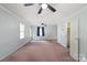 Large carpeted bedroom with great natural lighting, ceiling fans, and dual closets at 317 S Lineberry St, Troy, NC 27371