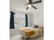 Bedroom featuring two windows with curtains and ceiling fan at 317 S Lineberry St, Troy, NC 27371