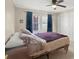 Bedroom with a large window with curtains and a closet is well lit from natural light at 317 S Lineberry St, Troy, NC 27371