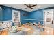 A bedroom with blue walls and a ceiling fan at 317 S Lineberry St, Troy, NC 27371