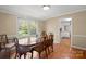 Traditional dining room featuring hardwood floors, bright windows, and classic dining set at 317 S Lineberry St, Troy, NC 27371