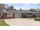 A brick home is shown with an attached garage and long driveway at 317 S Lineberry St, Troy, NC 27371
