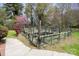 Landscaped garden area with planted vegetation, raised beds and perimeter fencing at 317 S Lineberry St, Troy, NC 27371