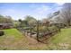Wide shot of the landscaped garden area with perimeter fencing at 317 S Lineberry St, Troy, NC 27371