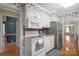 Well-lit kitchen featuring white cabinets and stainless steel appliances at 317 S Lineberry St, Troy, NC 27371