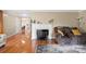 Cozy living room with a fireplace and pristine hardwood flooring at 317 S Lineberry St, Troy, NC 27371