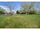 Expansive backyard featuring mature trees, a chain-link fence, and lush green grass at 3791 Richard St, Claremont, NC 28610