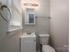 A cozy bathroom featuring a single sink, mirror, and a toilet in a neutral color scheme at 3791 Richard St, Claremont, NC 28610