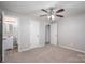 Primary bedroom featuring light carpeting, a ceiling fan, and an en suite bathroom at 3791 Richard St, Claremont, NC 28610