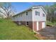 Exterior view of the home featuring gray siding, a brick foundation, and a garage at 3791 Richard St, Claremont, NC 28610