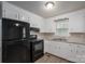 The kitchen features white cabinets, black appliances, and a stainless-steel sink at 3791 Richard St, Claremont, NC 28610