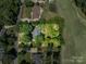 Overhead shot of landscaped home with brick and mature tree coverage at 3964 Deer Run Ne Dr, Conover, NC 28613
